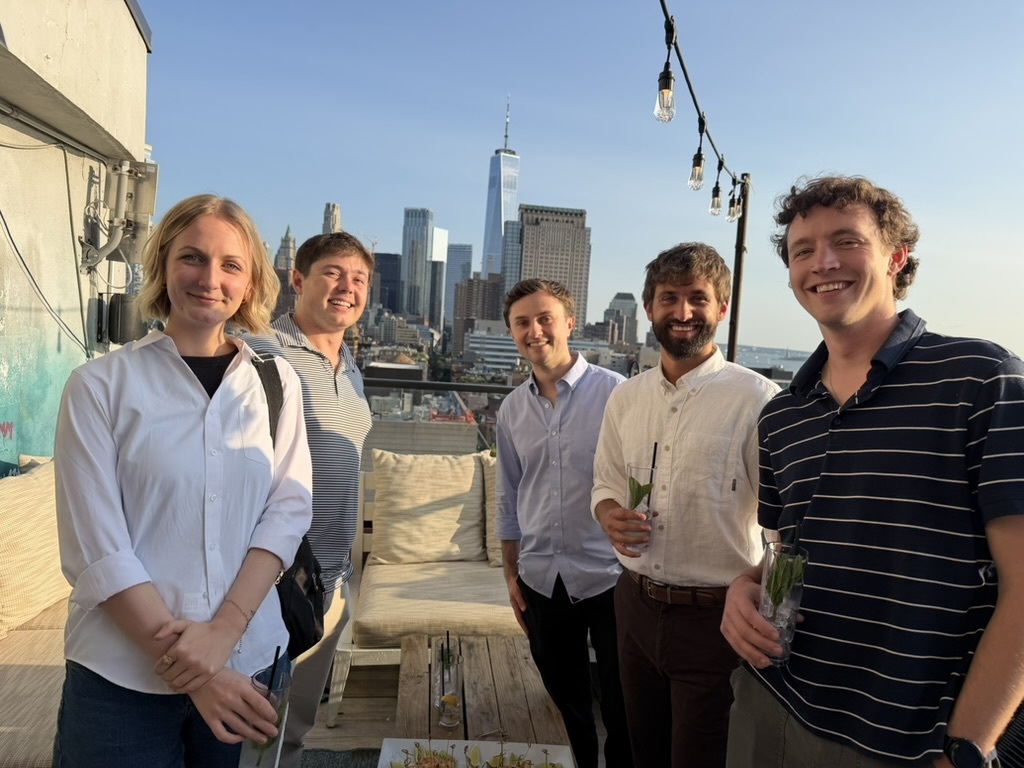 The team on a rooftop over lower Manhattan
