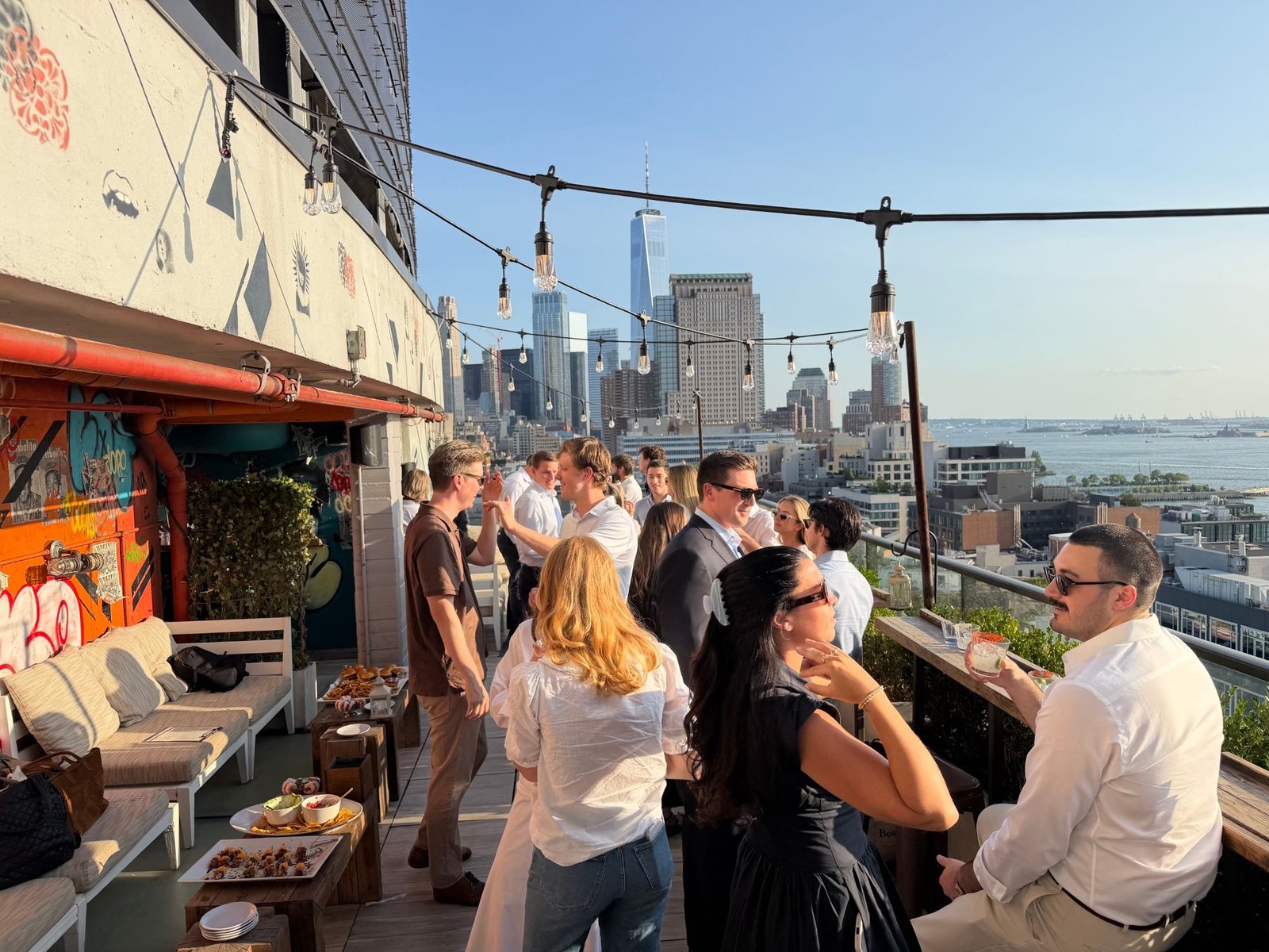 The team at a rooftop gathering over lower Manhattan